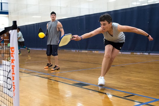 Chris Stanko, right, lunges for the ball at JF Hurley YMCA's Pickleball Tournament on March 24, 2018. (Photo by Rebecca Benson)